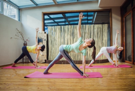 Three women doing yoga