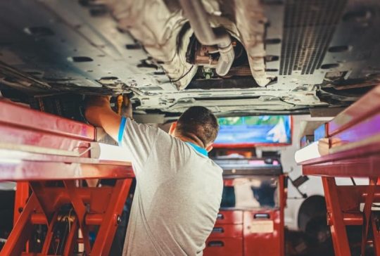 Mechanic working beneath a car