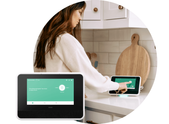 Woman control her home using her Smart Hub with Smart Hub in foreground