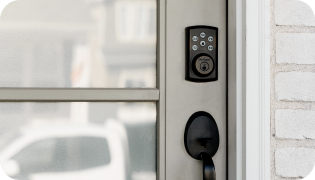 Kwikset Smart Lock on the front door of a home
