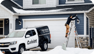 Smart Home Pro standing on a ladder installing a Vivint Outdoor Camera Pro