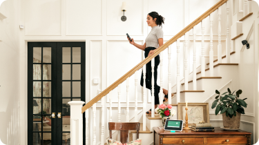 Woman in her home with the Vivint Smart Hub and Indoor Camera Pro