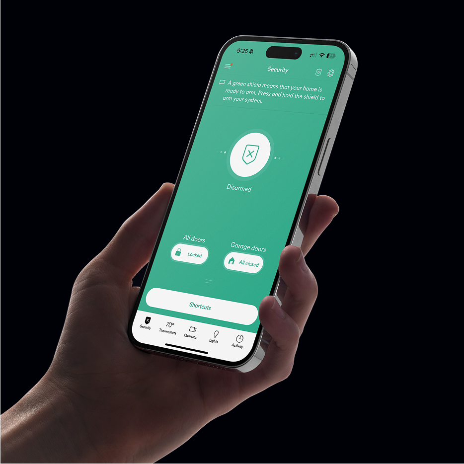 a hand holding a phone that shows Vivint app interface