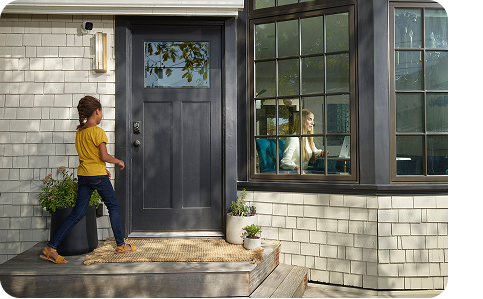 a kid going to the front door, with Vivint smart lock on the door