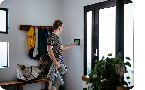 a man using Vivint smart hub next to the front dopr