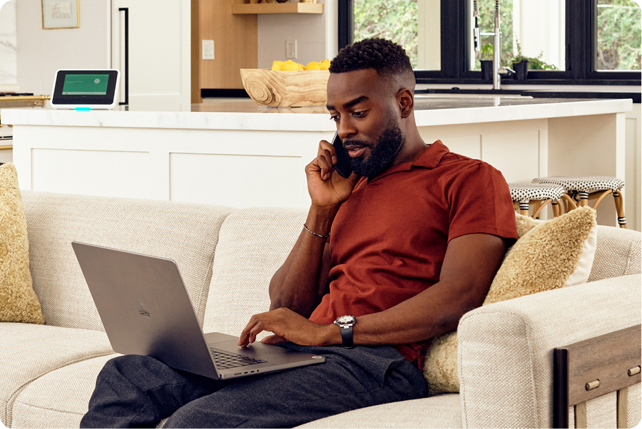 a man talking on the phone on a couch