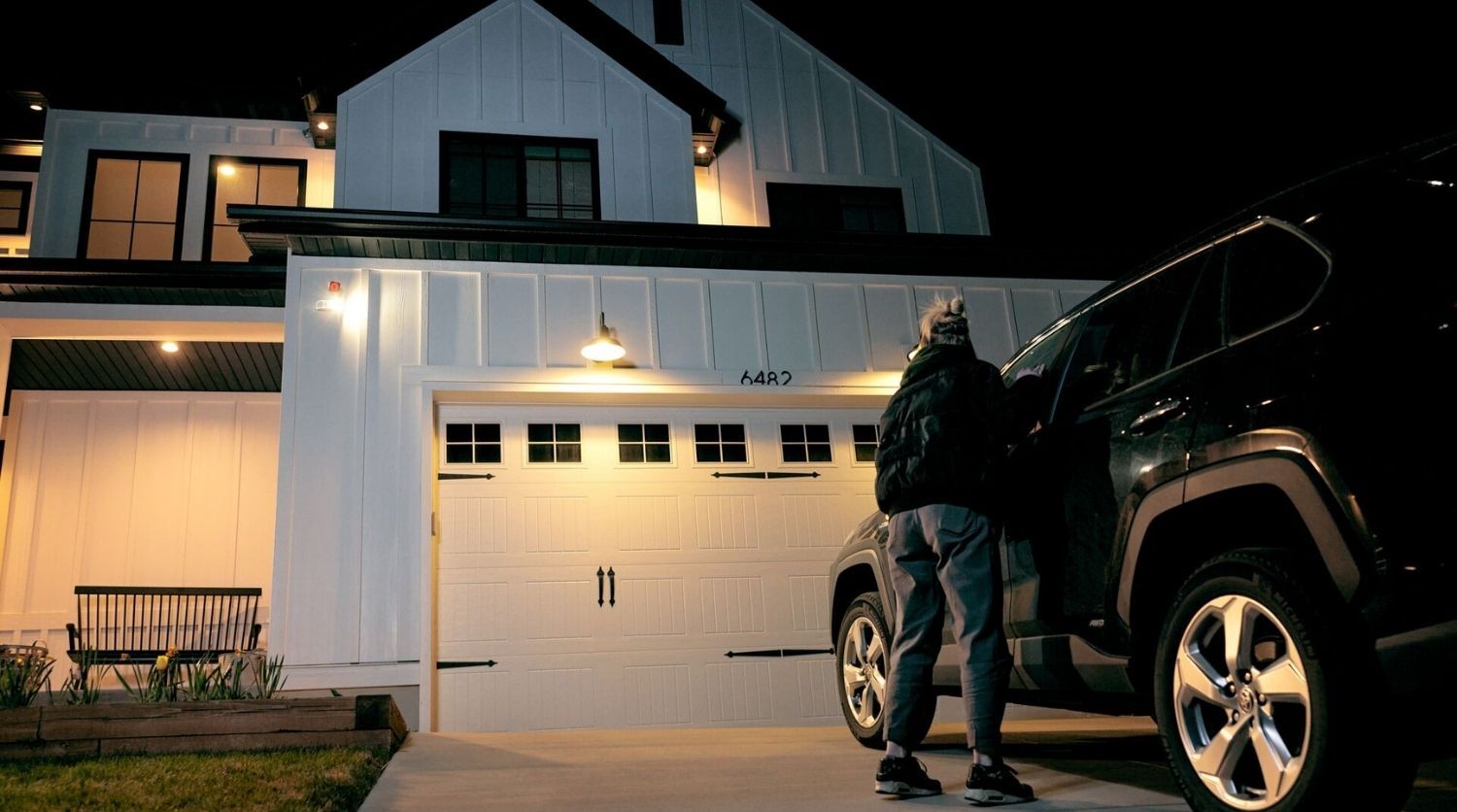 Night lurker near car spotted by outdoor camera