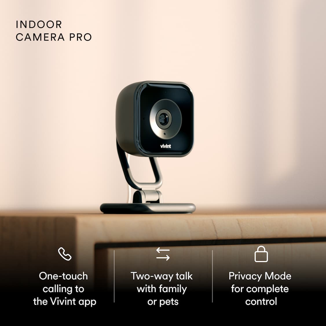 Vivint indoor security camera on a wooden table Features include one-touch app calls, two-way talk, and privacy mode