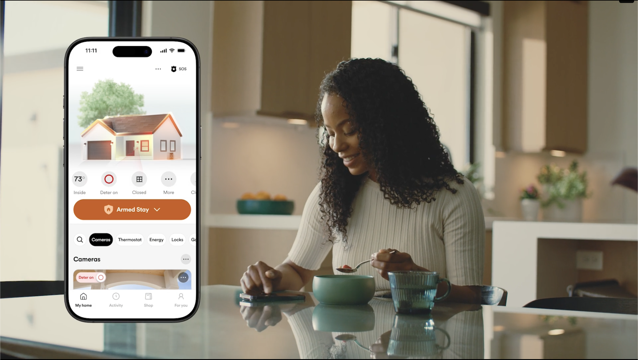 a woman looking at her phone, showing Vivint app