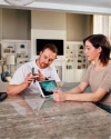 a Vivint rep talking to a customer in the kitchen next to the hub