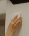 A hand touching Vivint glass breaker