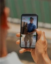 Person using the Vivint app to view a delivery man dropping off a package