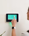 A person using Vivint smart hub on the wall