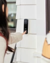 a person pressing the button on Vivint doorbell camera pro