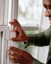 a person using Vivint window sensor installed on a window