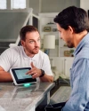 a Vivint rep talking to a customer in the kitchen next to the hub