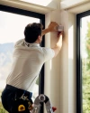 A Vivint rep installing a motion sensor next to the windows