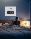 A man in bed next to a lamp with a on/off switch view from his phone