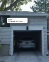 a car parked in a garage with a notification from Vivint saying "Your garage door is open."