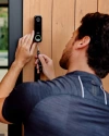 A Vivint rep installing a doorbell camera 