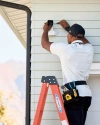 A Vivint rep installing an outdoor camera 