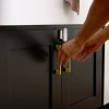 Vivint Window and Door Sensor on black cabinet doors with gold handles.