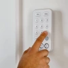 A hand using Vivint keypad
