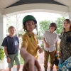Video footage of kids standing on a porch and ringing doorbell