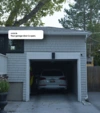A white car parked inside a small garage and a text bubble above the garage reading "Your garage door is open".