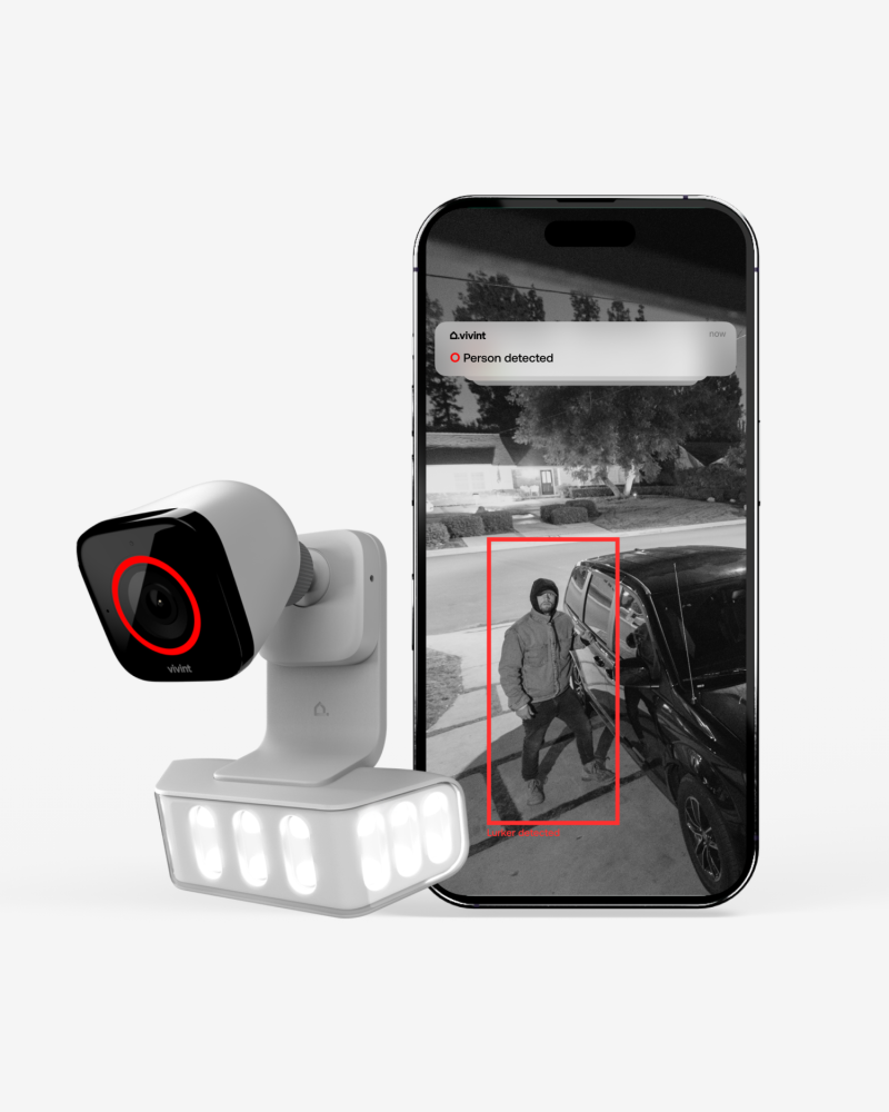 Spotlight Pro in front of security footage of a car thief approaching a car at night