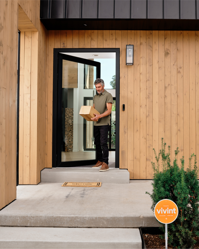 Homeowner retrieves a package from their porch thanks to Doorbell Camera Pro