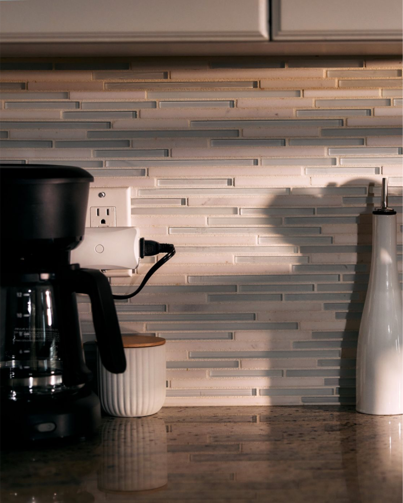 Vivint Smart Plug plugged into kitchen wall with a coffee maker plugged into it