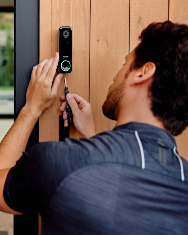A Vivint rep installing a doorbell camera 