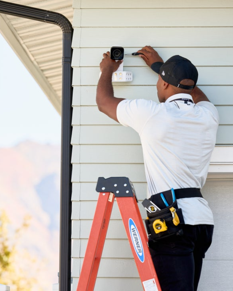 A Vivint rep installing an outdoor camera 