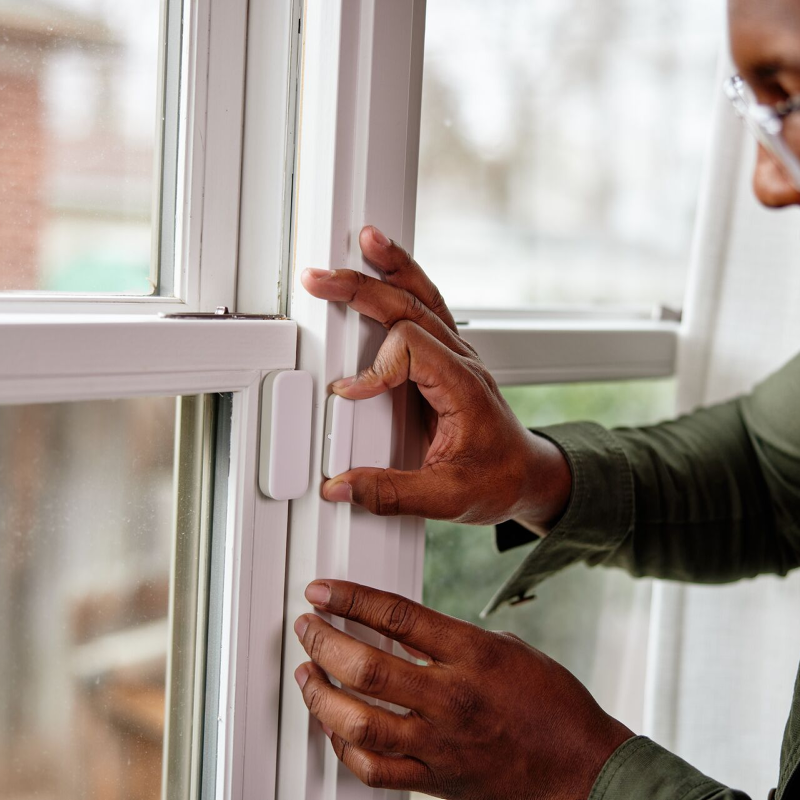 Person installing the Vivint Door and Window sensor on their window 