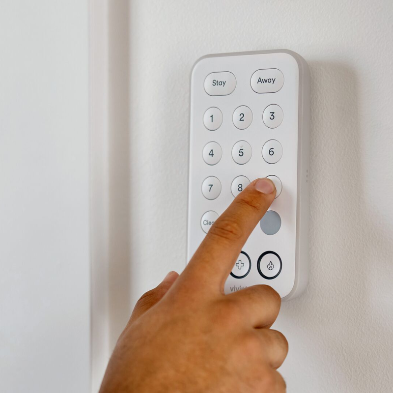 A hand using Vivint keypad