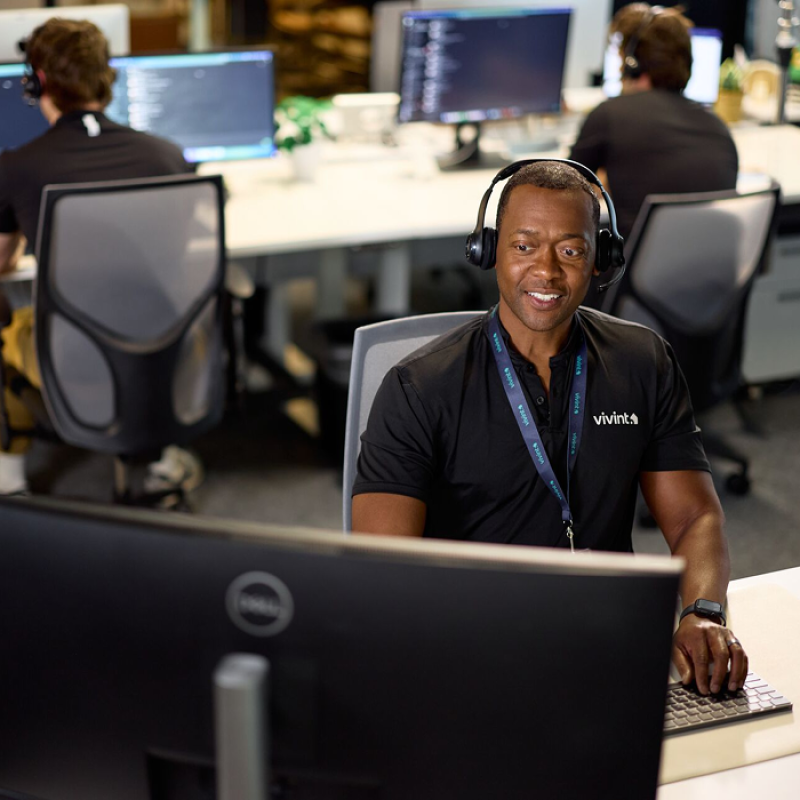 vivint employee with headset on monitoring system