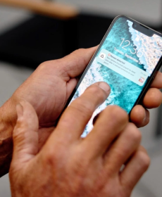 Close up of a person reading an app notification that came through of a person being detected