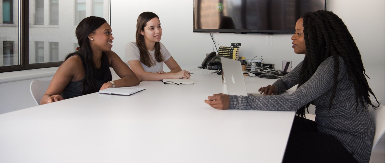 Two girls speaking with a Human Resources Representative