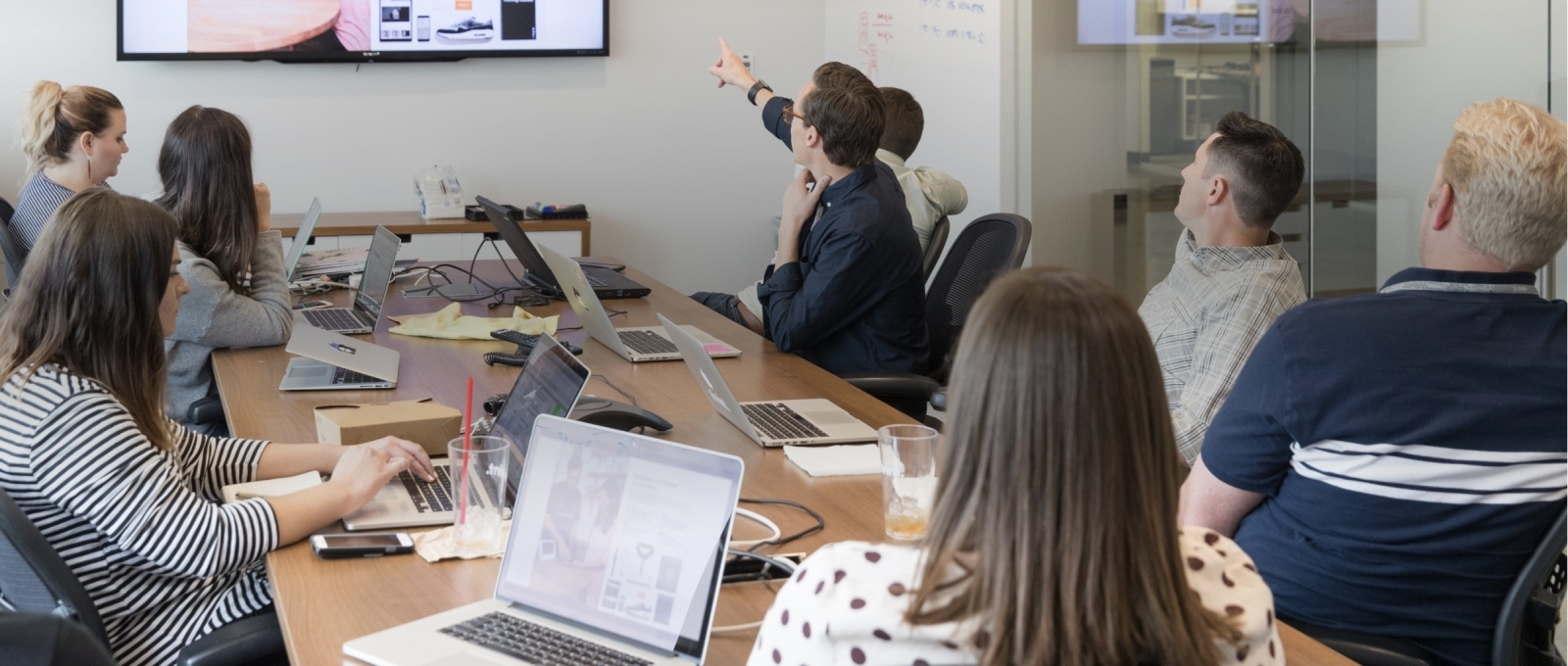 Employees gathered around a table in a conference room