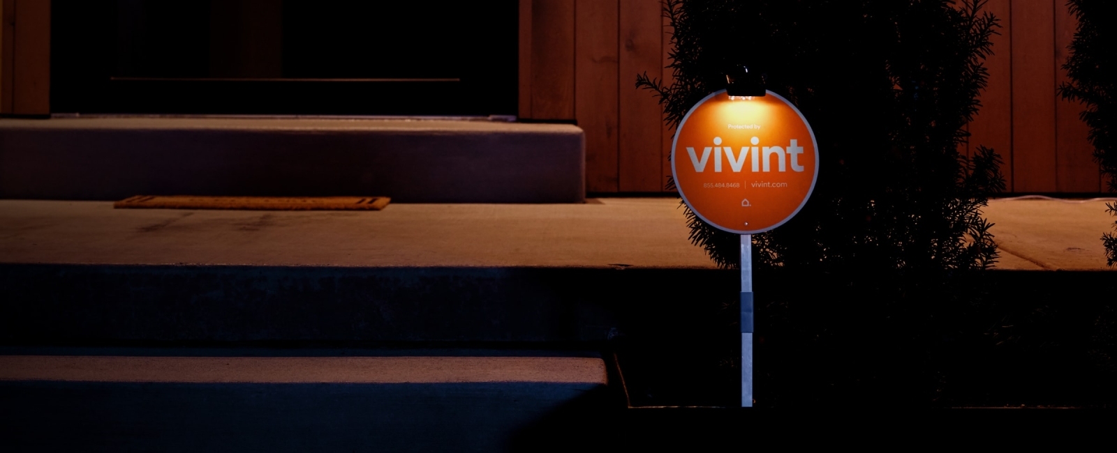 Vivint yard sign in the dark outside of a Vivint protected home