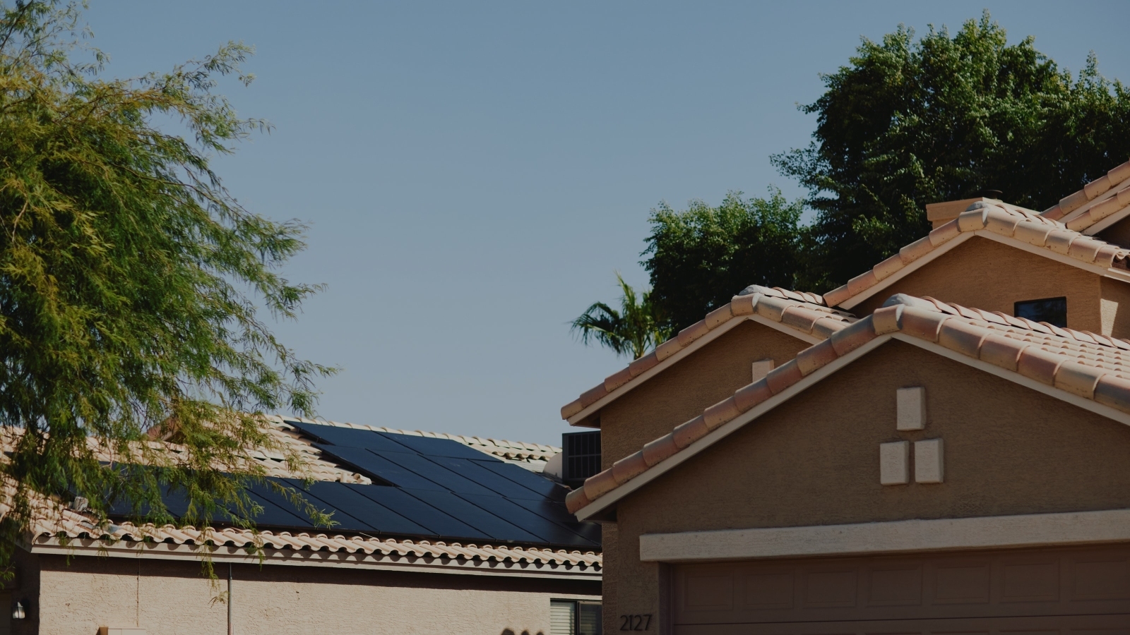 Close up view of top of house with solar panels on roof