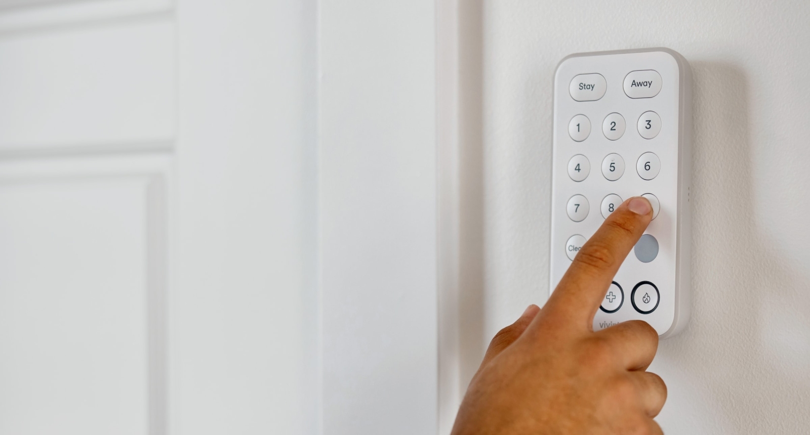 Person touching Vivint Keypad installed on wall