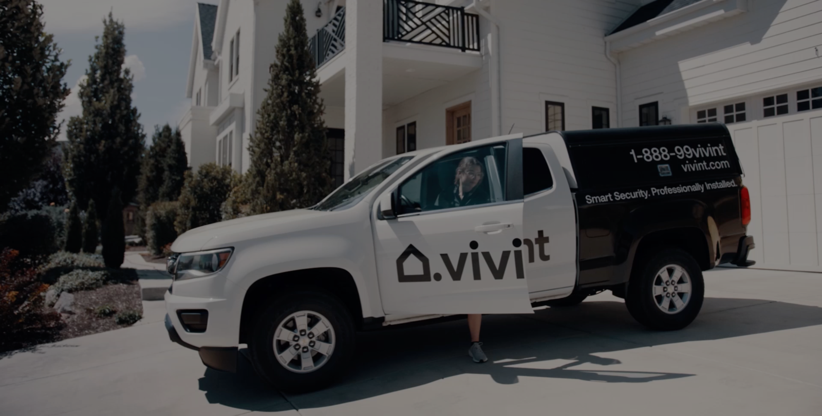 Smart Home Pro climbs out of their black and white Vivint technician truck