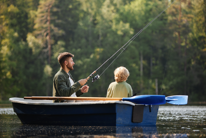 Father and son on a fishing boat.