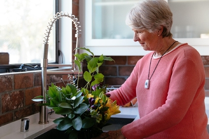 Woman wearing a senior alert system from Vivint.