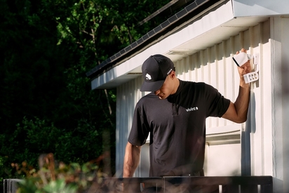 Vivint professional installing a Spotlight Pro floodlight camera.