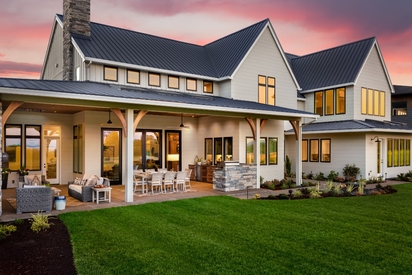 A home's exterior lit up with security lighting at night.
