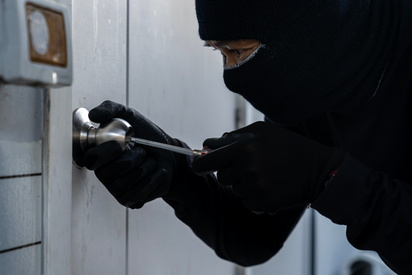 Burglar picking a lock.