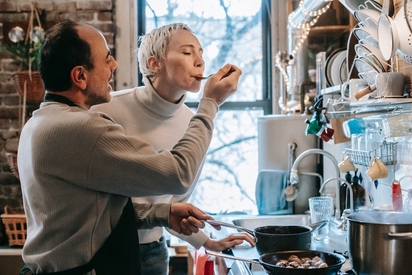 Couple making dinner together in the kitchen.